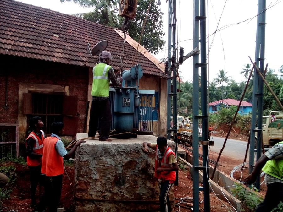 Distribution transformer being lifted onto its plinth by crane at a KSEB site